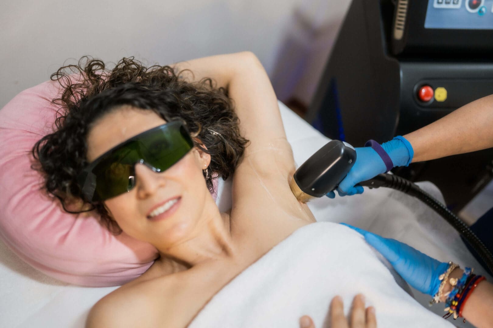 Woman receiving laser hair removal treatment.