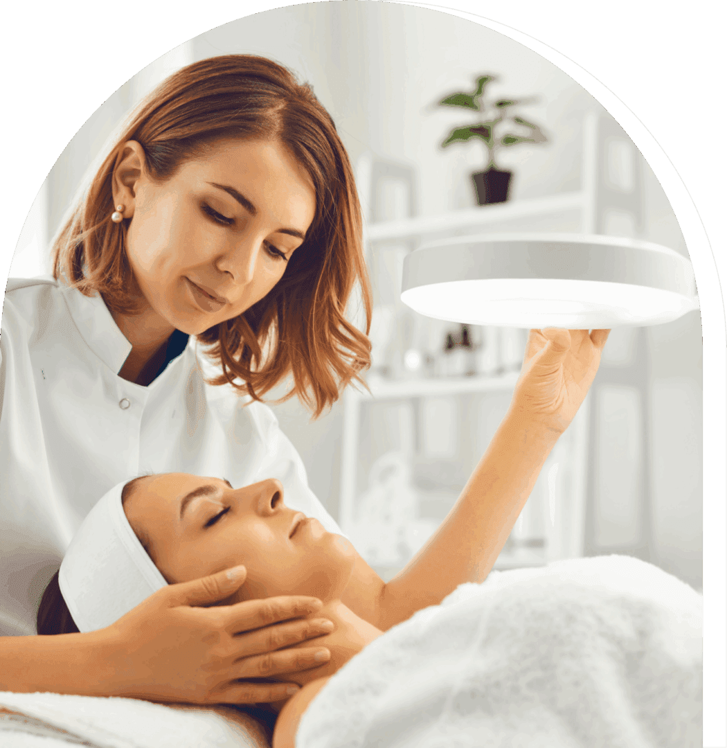 A woman receiving a facial treatment in a spa.