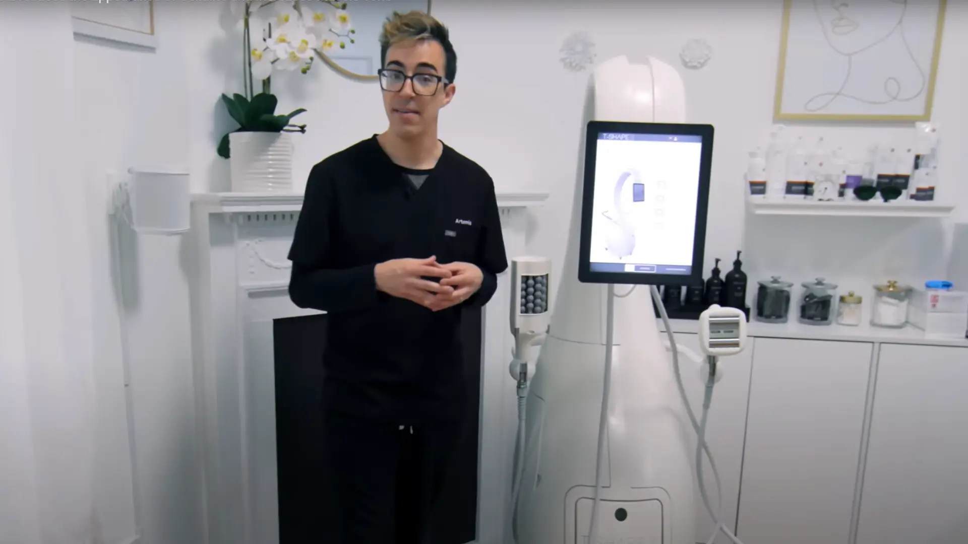 A man presenting medical equipment in a clinical setting.