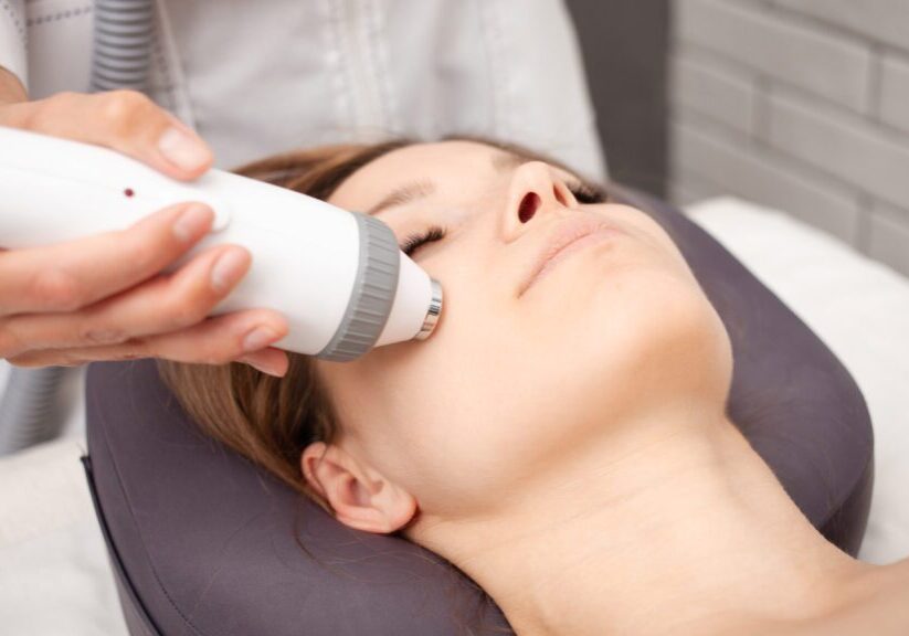 Facial treatment with handheld skin device.