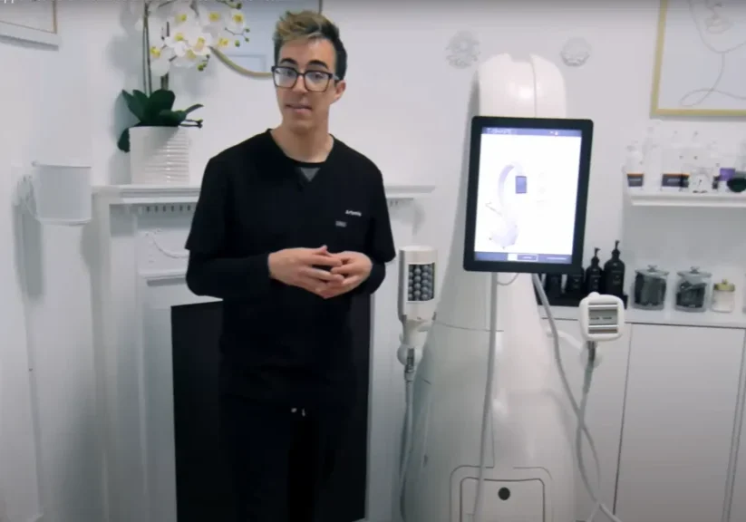 A man presenting medical equipment in a clinical setting.
